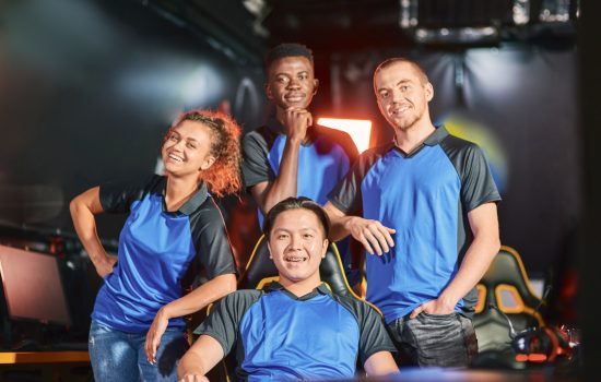 happy-multiracial-cybersport-team-smiling-at-camera-after-esport-tournament.jpg